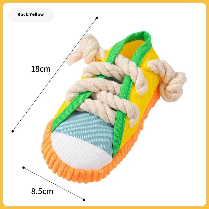 Slipper-shaped plastic dog chew toy in three colours with bends for chewing