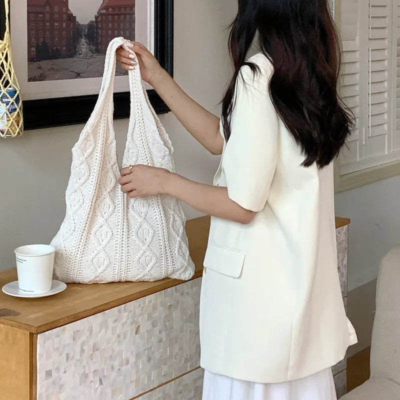 Women's retro-style knitted crochet tote bag with double shoulder straps in a solid colour.