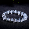 Women's white crystal pyramid bead bracelet with Ruyi element on wrist