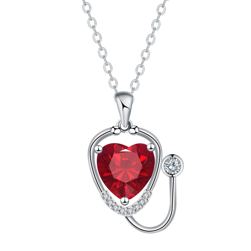 Red diamond copper necklace with stethoscope-shaped pendant featuring wings and cross detailing