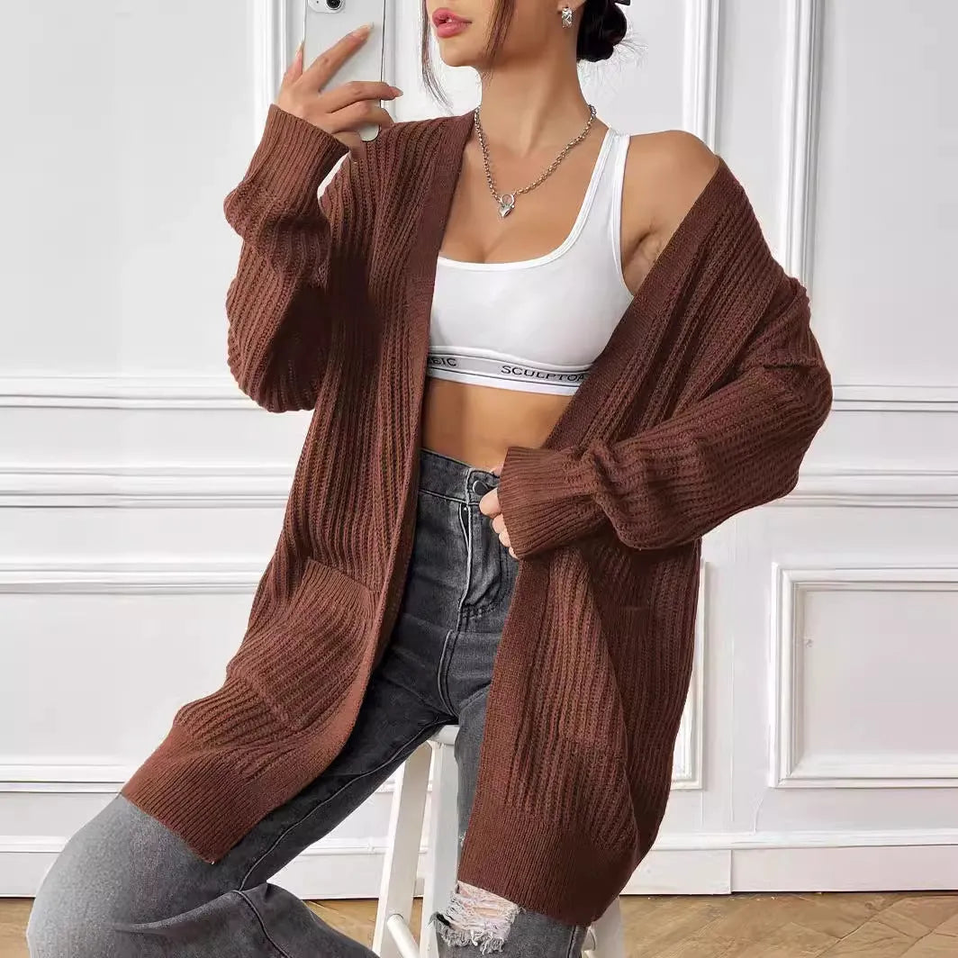 Loose fit women's acrylic cardigan sweater with double pockets in solid color