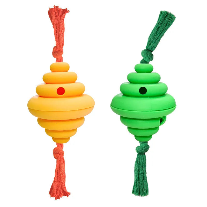 Green and yellow silicone dog ball with attached knot rope toy on grass.