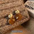 A set of three handmade geometric tassel earrings for women: Amber, round piece, and water drop styles.