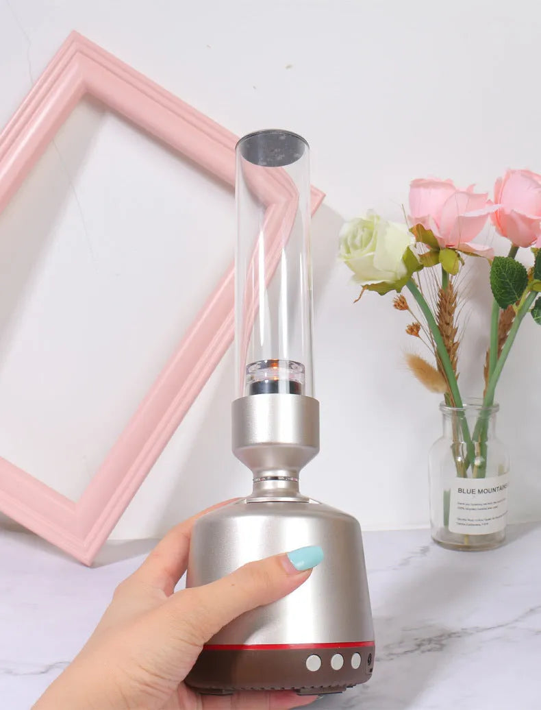 White silver Bluetooth speaker with candlelight night light feature measuring 90x277mm