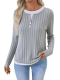 Women's black grinding stripe fake two-piece pullover sweater with round neck and button detail.
