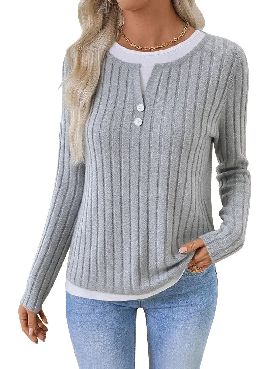 Women's black grinding stripe fake two-piece pullover sweater with round neck and button detail.