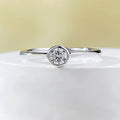 Minimalist silver women's ring with a crown shape and linear detailing in gold or platinum colour.
