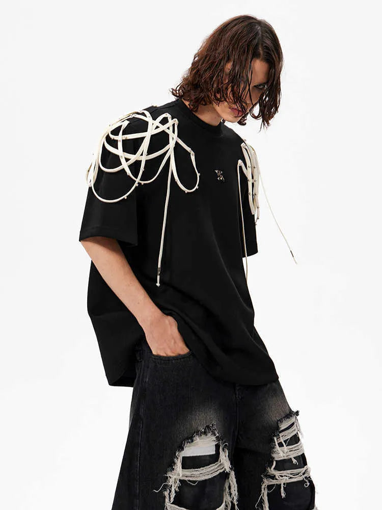 Black loose-fit short-sleeved T-shirt with padded shoulders and rivet ribbon detail.