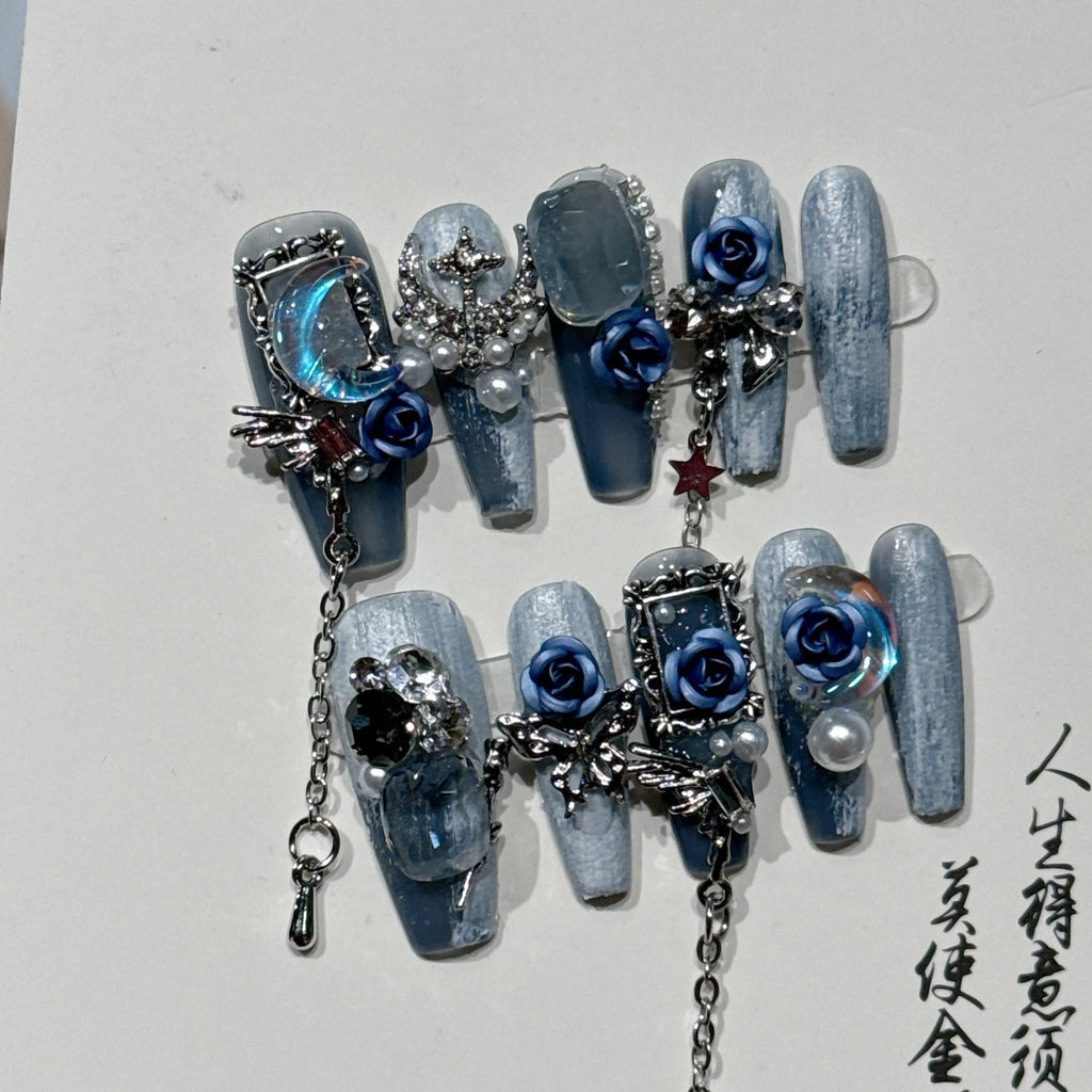Heavy industry blue manicure nails with rose and tulip floral patterns in plastic armour suit packaging