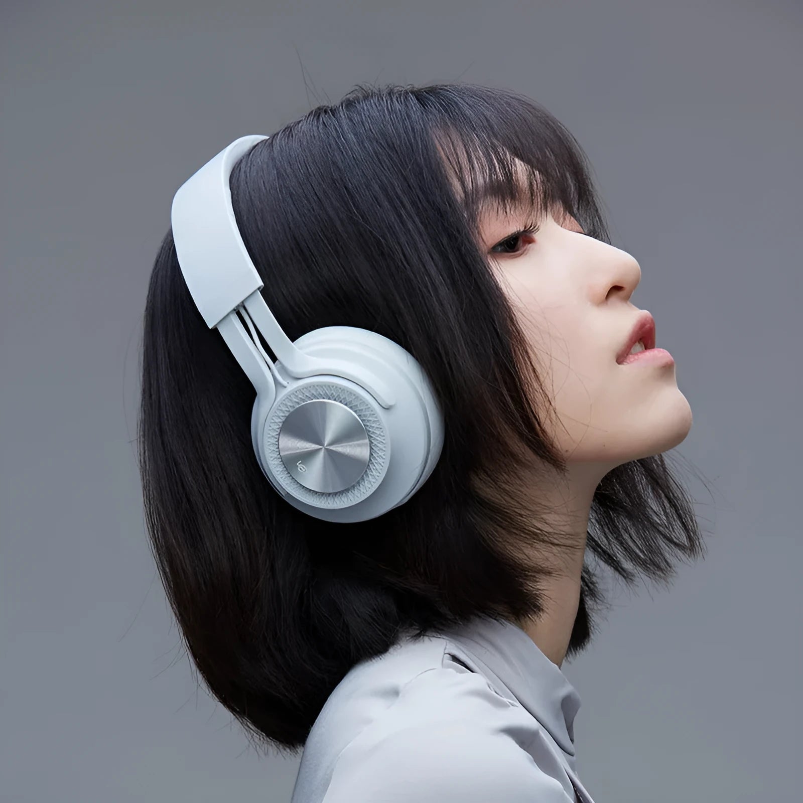 Sports wireless Bluetooth headset in red, grey, green, or black colours showing earpiece design