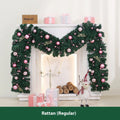 Pink artificial Christmas rattan garland with small berries and warm white LED lights draped on a mantelpiece.