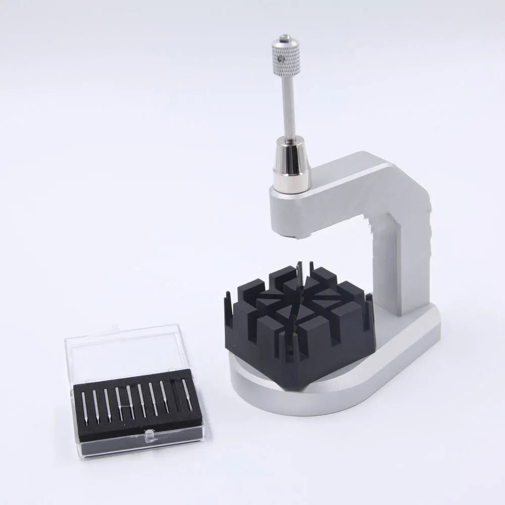 Silver tool steel press strap removal tool with 0.50-1.60mm blade specification on a work surface.