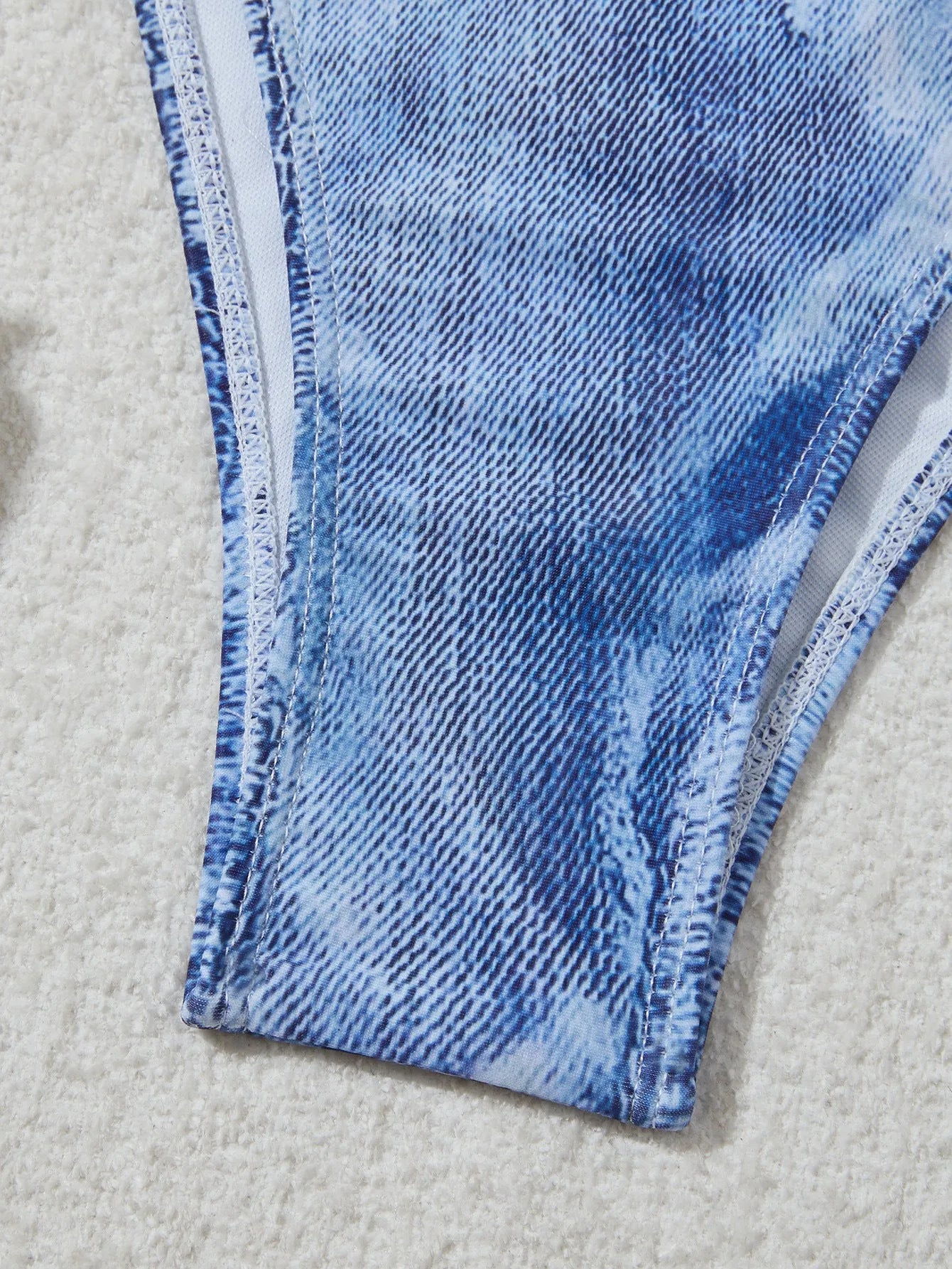 Women's denim blue printed bikini set with adjustable straps, shown as a two-piece swimsuit.