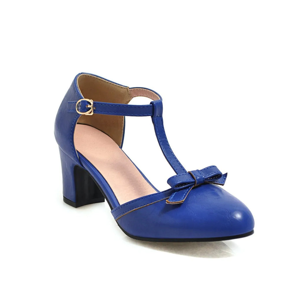 Women's apricot chunky heel sandals with a hollow-out round toe, T-strap buckle, and a black bow detail.