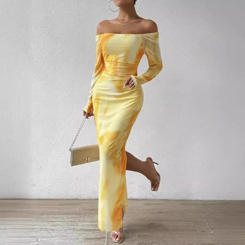 Woman wearing a printed gradient colour mesh fishtail dress with pleats and a square collar