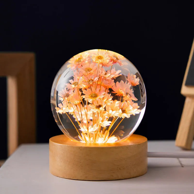 Preserved dandelion inside a glowing resin crystal ball night light on a beech wood stand.