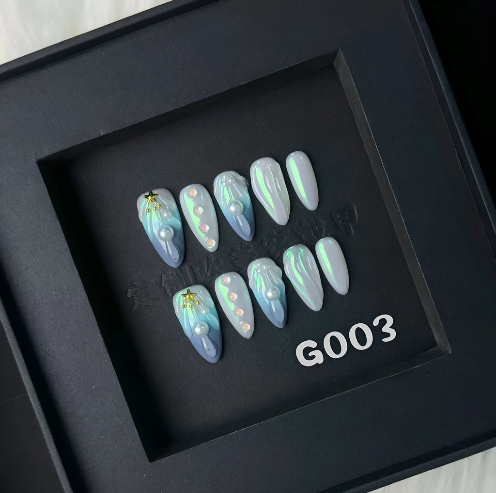 Blue plastic artificial nail tips set on a card, showing sizes labelled XS, S, M, and L.