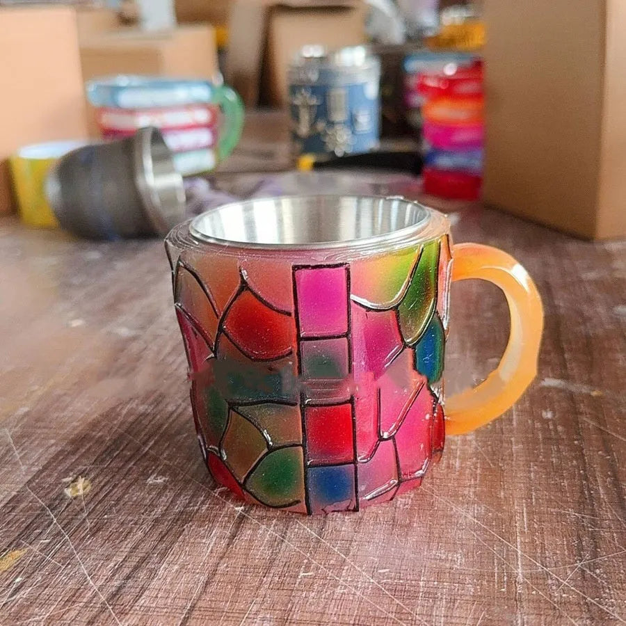 Decorative synthetic resin coffee cup with painted book mark design, 13cm high