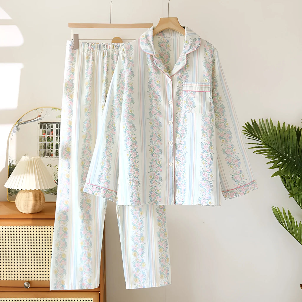 Red and white small fruit patterned cotton gauze long-sleeved top and trousers homewear set laid flat.