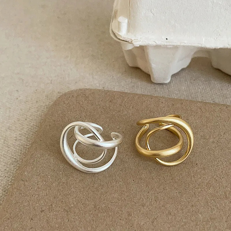 Geometric open ring with interlaced matte metal pattern in gold or silver electroplated finish