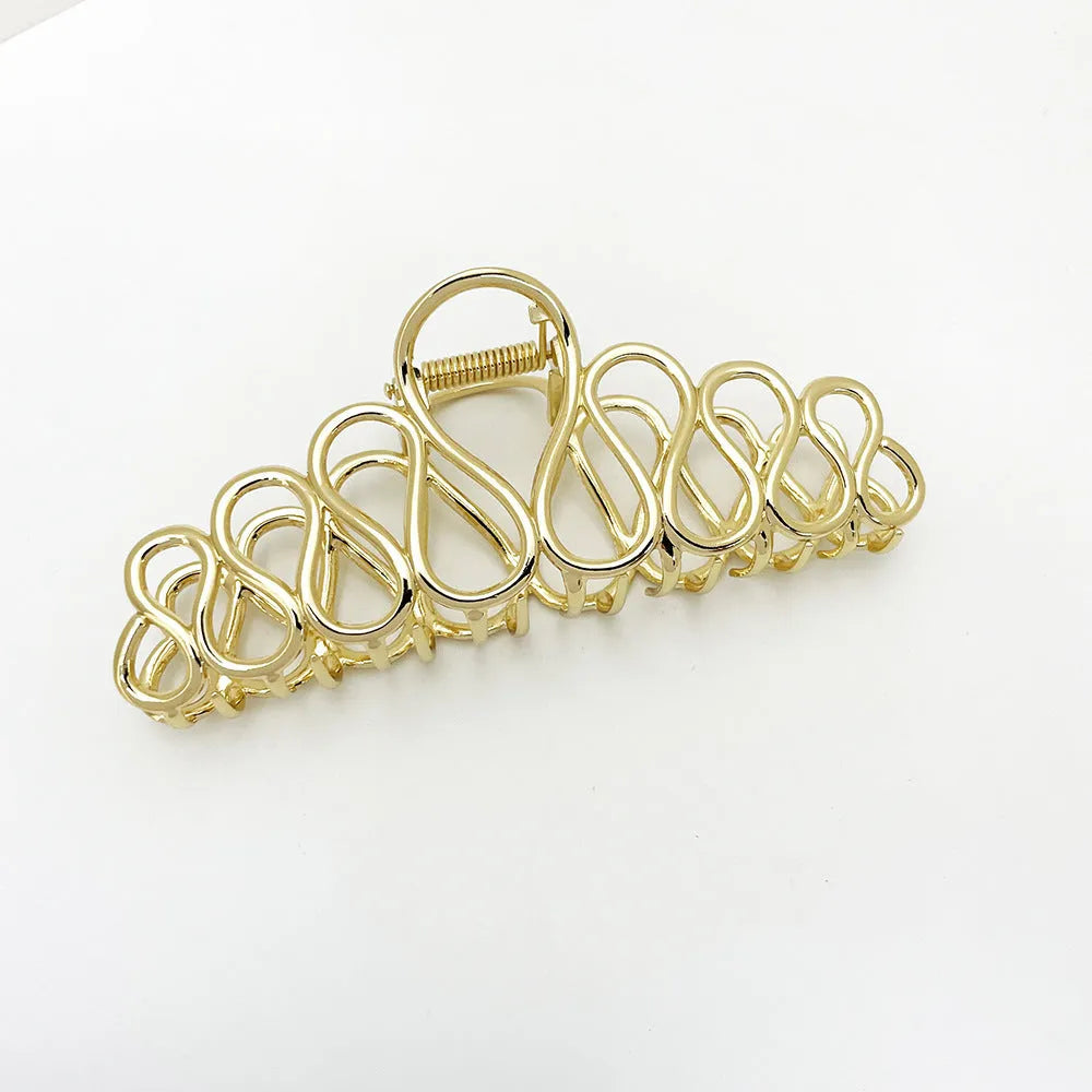 Large gold and silver alloy hair clip with a minimalist design and tassel detail for updo hairstyles.