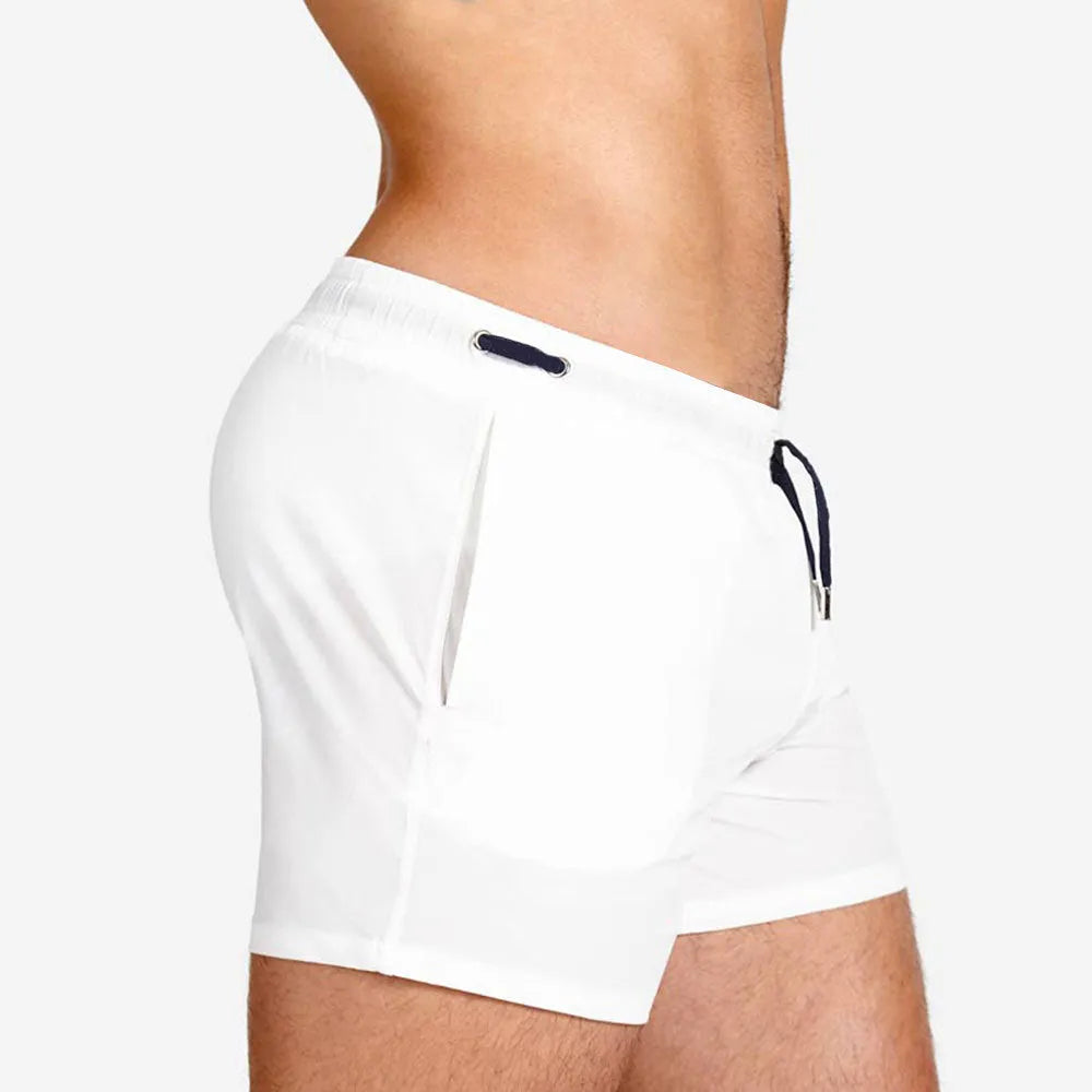 Mesh-lined sports shorts in polyester fabric with elastic waistband available in multiple colours