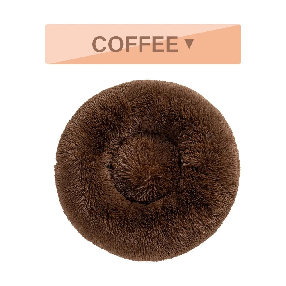 Fluffy grey donut dog bed with raised rim, shown with a small dog sleeping inside.