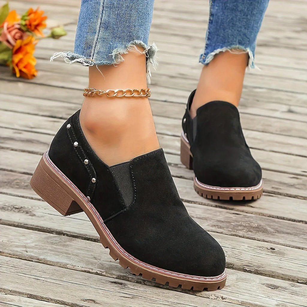 Light brown suede women's ankle boots with low heel and elastic band on a white background.