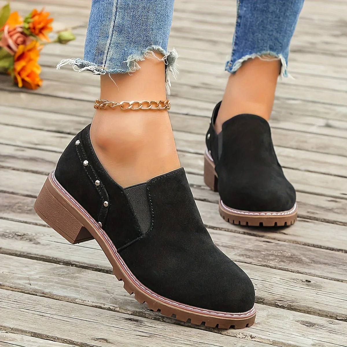 Light brown suede women's ankle boots with low heel and elastic band on a white background.