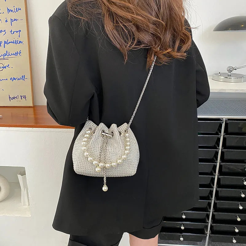 Women's diamond pattern PU leather crossbody shoulder bag with Western chain detailing and bucket shape