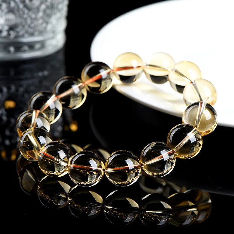 Natural citrine scattered beads ball bracelet showing polished stones in a 7A or 6A grade colour on a wrist.
