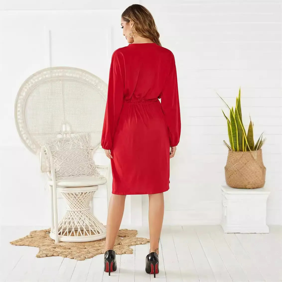 Black or red A-line mid-length dress with elastic waist, long sleeves with elastic cuffs, and a loose cinching belt.