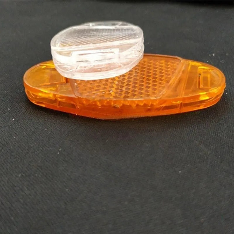 Bicycle plastic spoke reflector in white or yellow measuring 7.2cm length by 3.5cm width