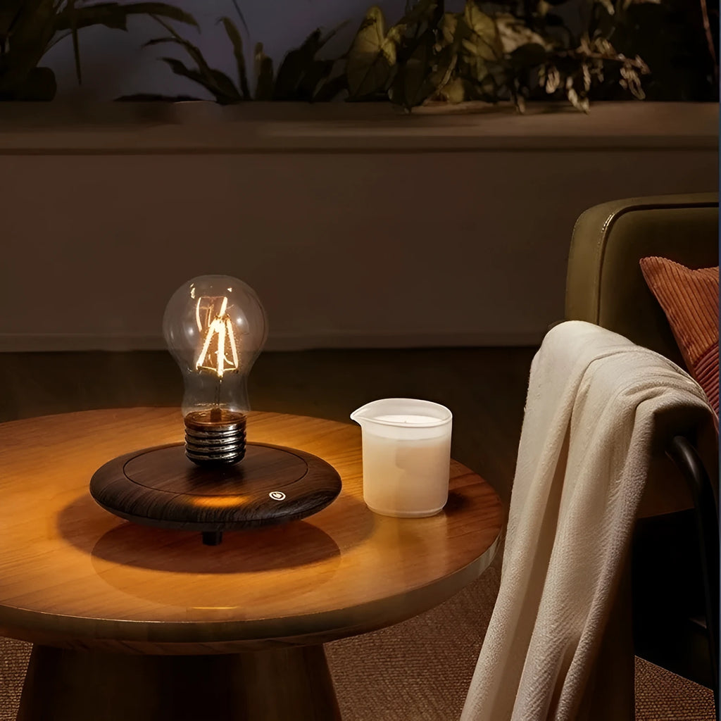 Creative small iron art night lamp with suspension bulb design on a black wood grain base.