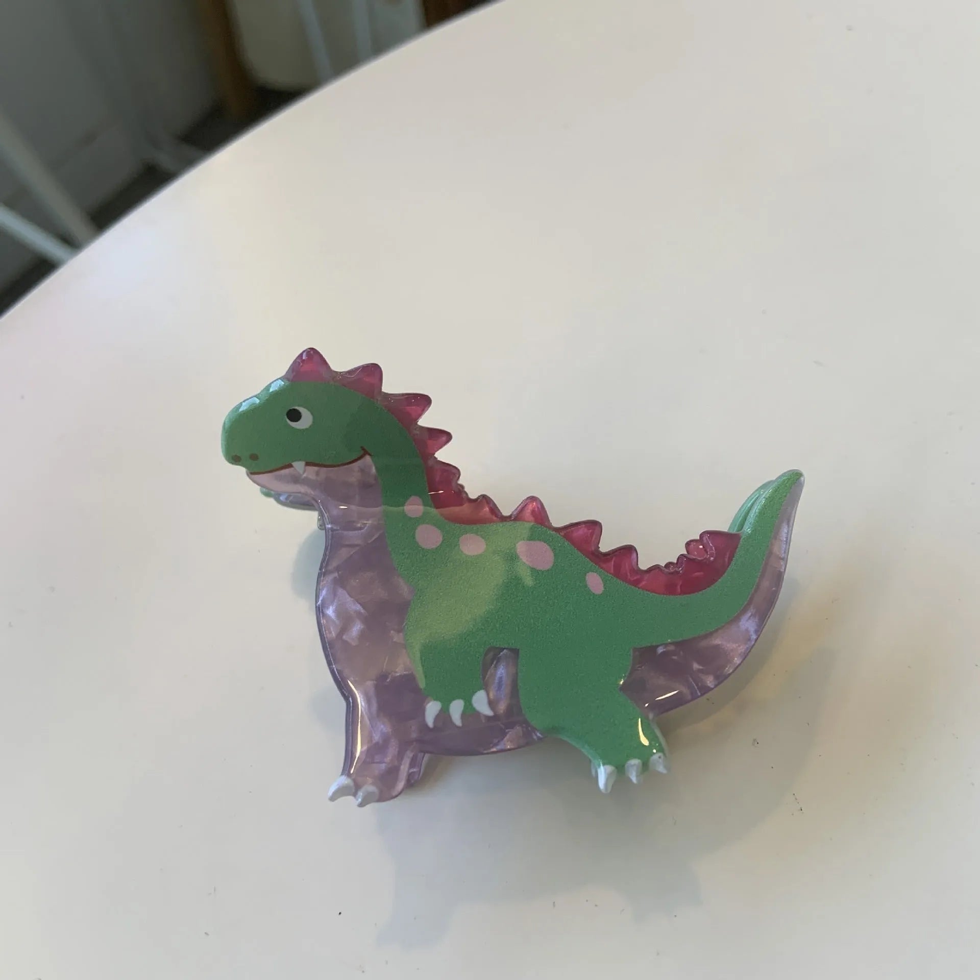 Dinosaur acrylic jaw hair clip showing grip mechanism and detailed dinosaur design in available colour options