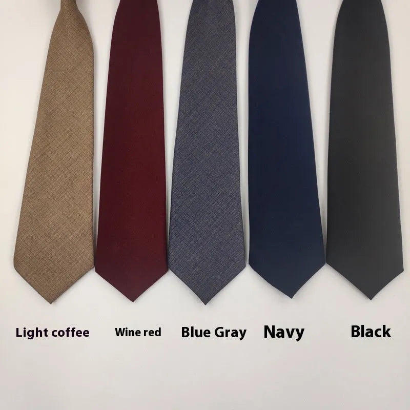 Solid navy blue cotton men's tie with arrow style on a white background.