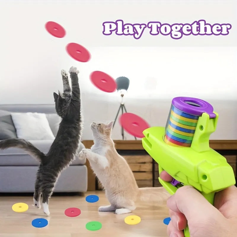 Green durable plastic battery-free cat toy launcher with a foam disc on a wooden floor.