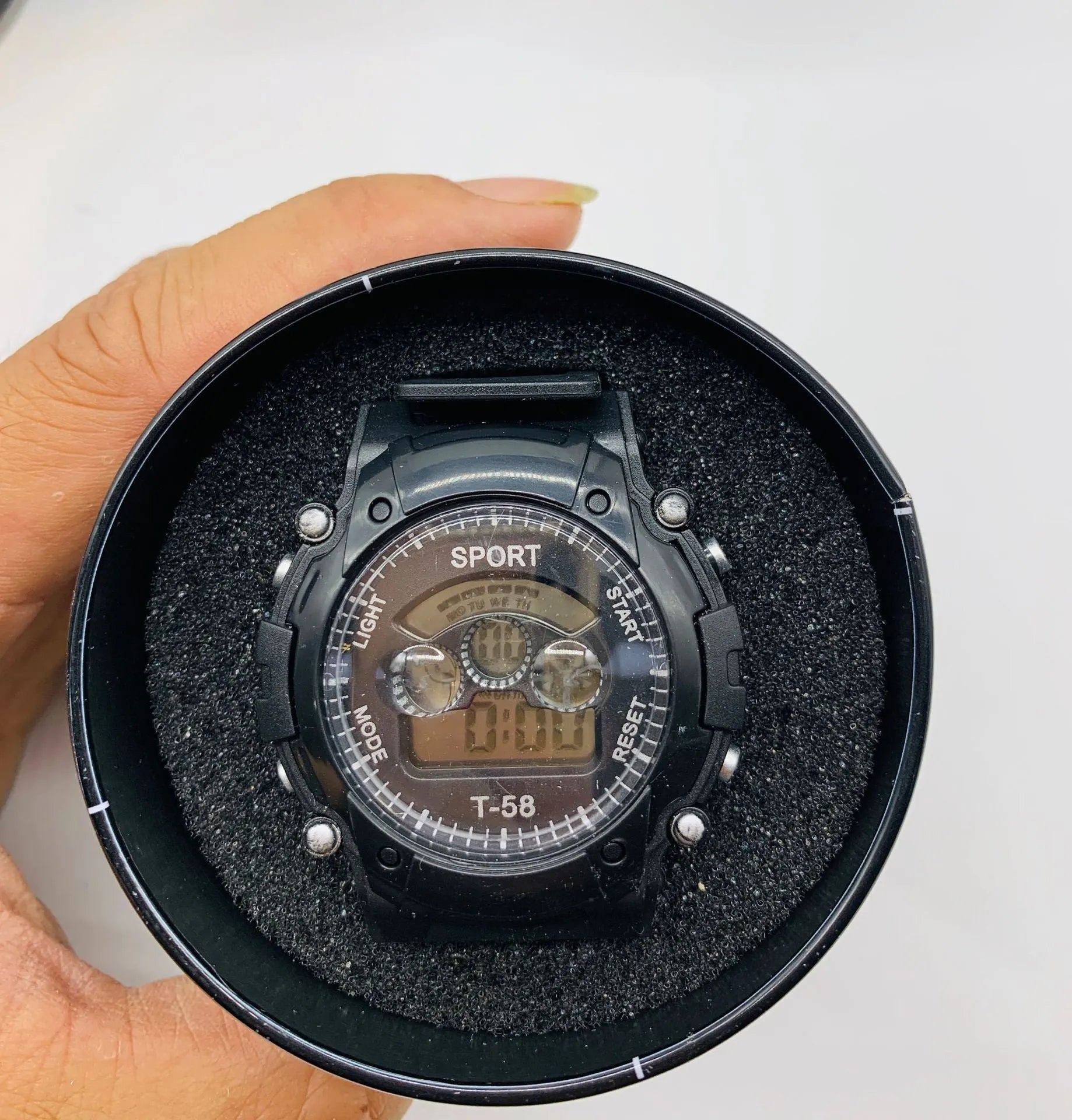 Children's digital sports watch with silicone strap and plastic case on wrist.