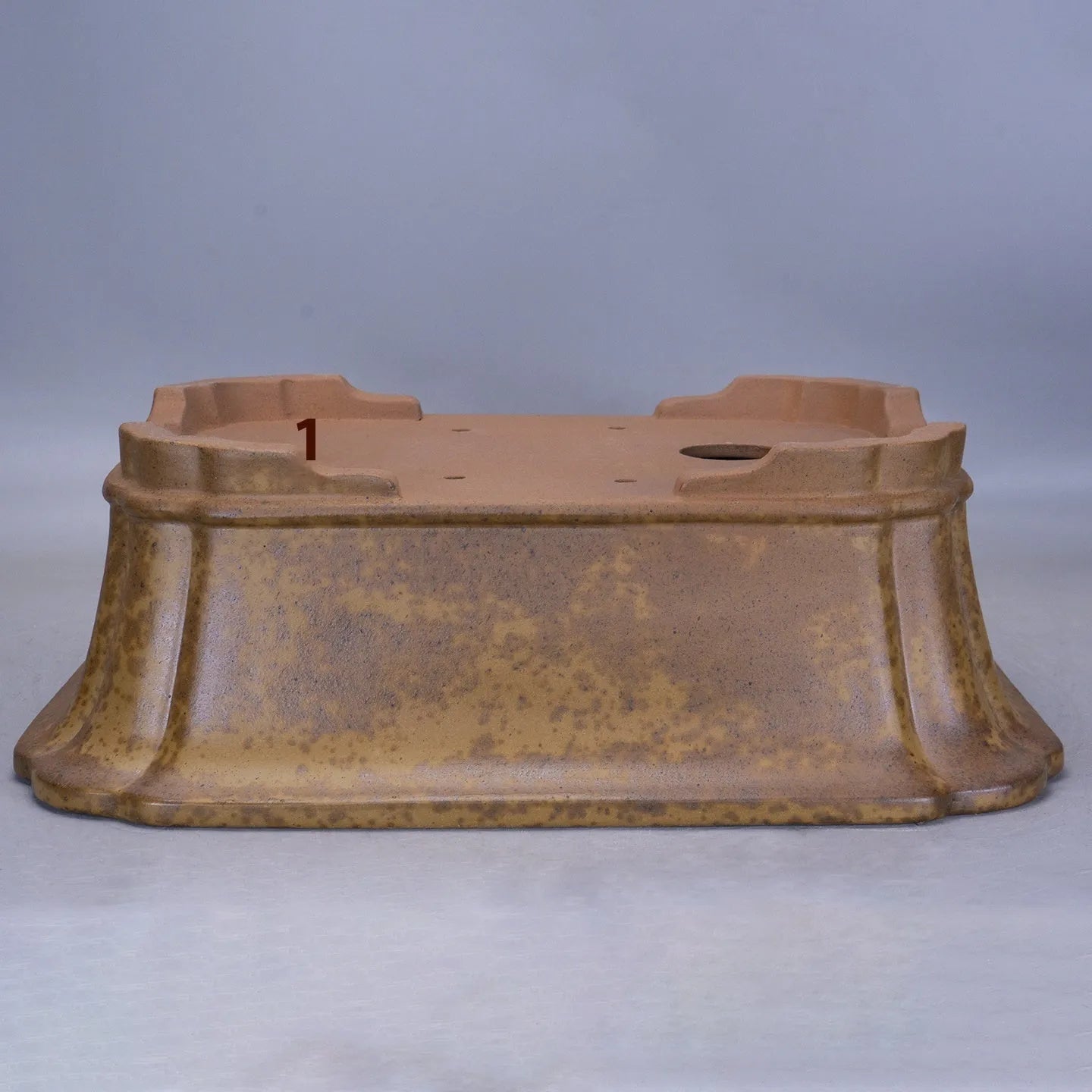 Purple sand rectangular flowerpot showing textured segment mud construction and geometric angles.