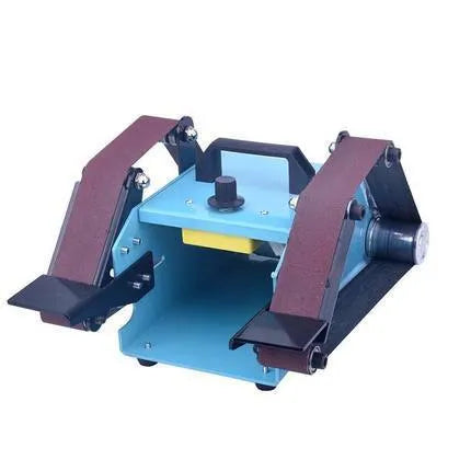 Blue desktop dual-axis belt sander with variable speed control and included knife sharpening tool on a workbench.