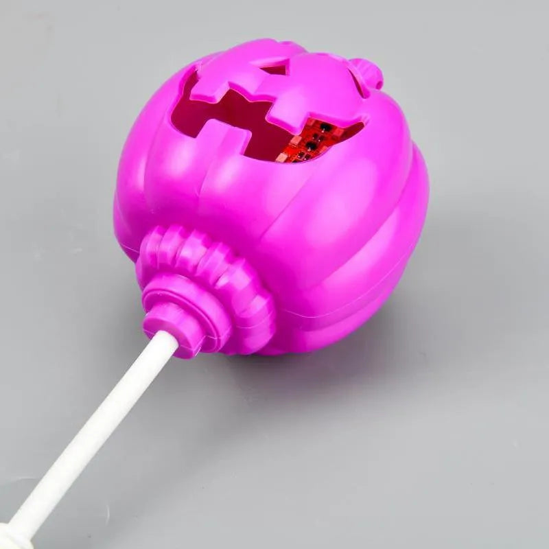 Plastic pumpkin lamp with USB port showing yellow and purple light options