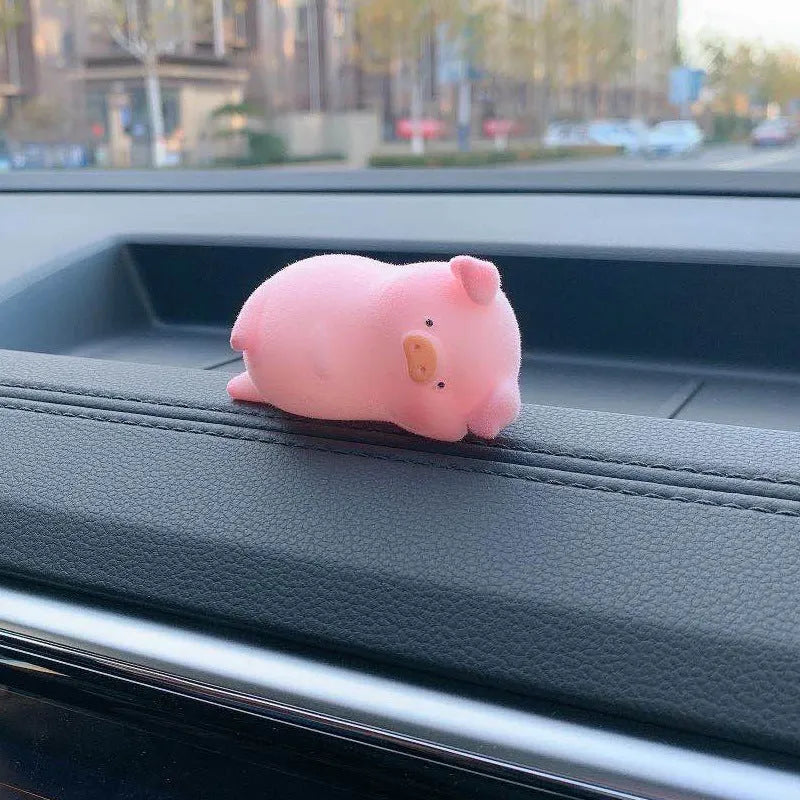 Colourful 3D resin cartoon pig figurine car decoration on a car dashboard