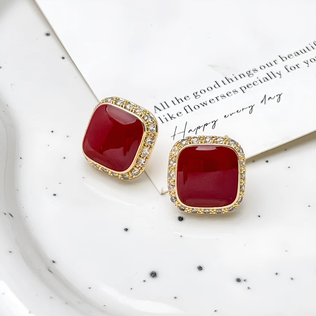 Red geometric square earrings with inlaid design details on alloy material