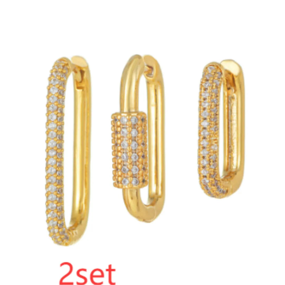 Geometric ear clips set with micro inlaid zircon detailing on copper, showing ellipse and quadrilateral shapes in gold and white finishes