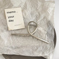Silver metal hair claw barrettes collection showing multiple designs including wave, rose, and bow shapes