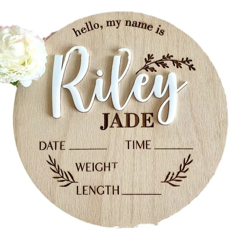 Square wooden baby name label displaying personalised birth details for nursery décor.