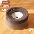 Green non-wet mouth suspension pet water bowl for dogs and cats on a white plate