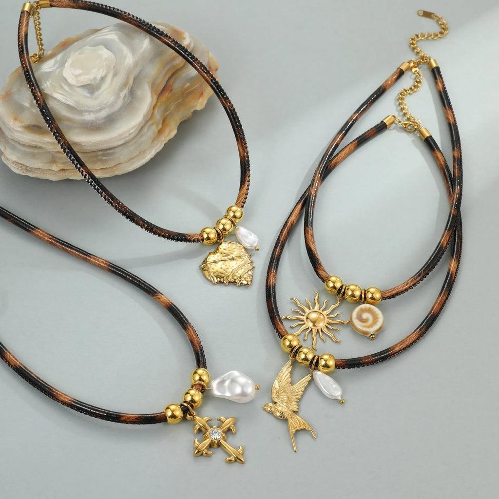 Gold plated stainless steel necklace with geometric leopard pendant and adjustable chain on white background