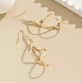 Gold-coloured spiral design alloy earrings with elliptical geometric details