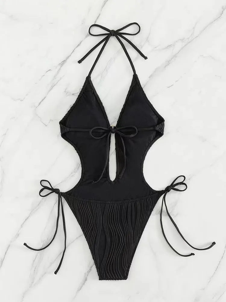 Women's black triangle bikini with white lace-up fastening detail on the front